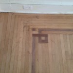 Detail of quartersawn solid White Oak hardwood flooring with rift-in Walnut feature strips
