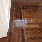 Refinished old hardwood floors shine as finish dries