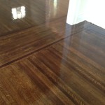 Refinished old hardwood floors shine as finish dries