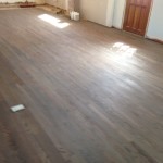 Applying classic gray DuraSeal stain to wood floors