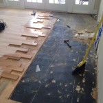 Water damaged wood flooring area being repaired