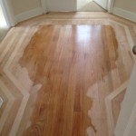 Inlaid wood floor being sanded for refinishing