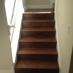 Bottom section of refinished wood stairs and landing