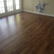 Empty room with wooden floor and windows.