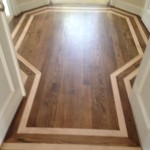 Refinished Red Oak wood floor with inlay