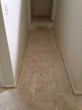 Bare hallway subfloor following tile removal