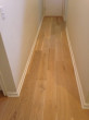 Wire brushed engineered White Oak wood flooring installed in the hallway