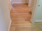 Wire brushed engineered White Oak wood flooring installed in the front hall