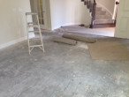 Carpet and padding removed from concrete subfloor for wood flooring installation