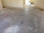 Carpet and padding removed from concrete slab subfloor for wood flooring installation