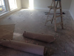 Carpet and carpet padding removed from concrete slab subfloor for wood flooring installation