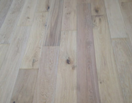 Installed wire brushed engineered white oak floor with white stain