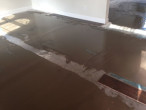 Leveling concrete slab subfloor for wood flooring installation