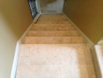Looking down the travertine stairway from the upper landing to the intermediate landing