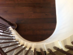 View of wire brushed, engineered White Oak wood flooring after installation, from the spiral staircase