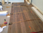 Installing new European White Oak wood flooring using special wood floor straps