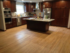 View of new Kitchen Cabinets and Island by Horn Builders, on solid Red Oak flooring repaired by Dan's Floor Store