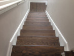 View of new European Oak wood floor and treads sanded and stained to match