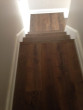 View of new European White Oak wood floor and stair treads sanded and stained to match