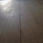 5 inch wide solid White Oak plank flooring installed with nickel spacers