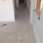 Preparing concrete subfloor prior to installing plywood subfloor