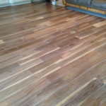 Wide engineered, weathered Walnut flooring with white details for the beachy look