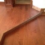 New Maple wood flooring installed with seams aligned on upper and lower levels