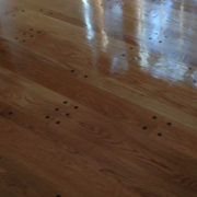 Shiny wooden floor with reflection and patterns.