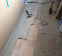 Gluing and nailing plug bored white oak planks in place