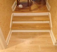 New solid Red Oak stair treads match existing floor on upper level