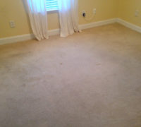 Old carpeting on the bedroom floor, prior to removal