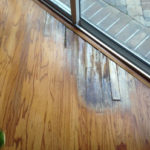 One area of water damaged, rotary sawn Red Oak flooring to be repaired
