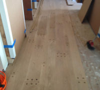 Pegged look white oak flooring planks being installed