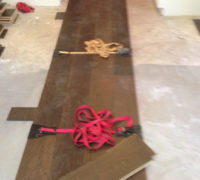 Special straps hold wide wood flooring planks together during installation