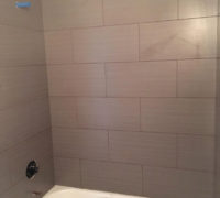 Wood look tile installed - tub & shower surround