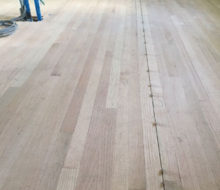 Red Oak wood flooring with nickels installed to make expansion joints