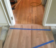 Aligning new red oak flooring with existing wood flooring planks