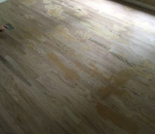 Applying Red Oak filler to installed new Red Oak flooring