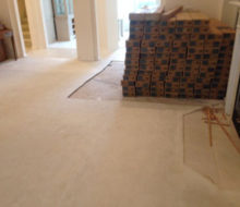 Boxes of Bella Cera French Oak wood flooring where carpeting has been removed