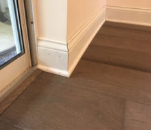 New baseboards and shoe molding with installed French Oak wood flooring