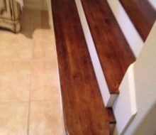 Several stained and finished Birch stair treads, at the bottom of the staircase