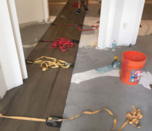 Special flooring straps hold wide planks together during installation