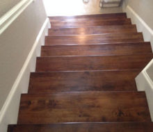 View of lower portion of stained and finished Birch stair treads from above