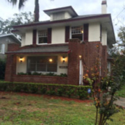 Two-story brick house with front porch.