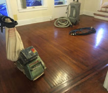 Drum floor sander and vacuum on old white oak flooring for refinishing