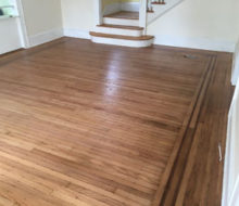 Face nailed white oak flooring with walnut strip border after refinishing