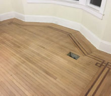 Face nailed white oak flooring with walnut strip border after sanding and hand scraping