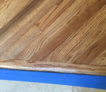 Header board for diagonal sanded and stained red oak wood flooring