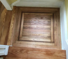 Old heart pine stair treads and face-nailed white oak landing with walnut strip border after refinishing