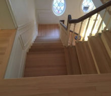 After sanding and hand scraping wood flooring, stair treads, and landings